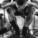 Monochrome image of exhausted soccer player resting in locker room.